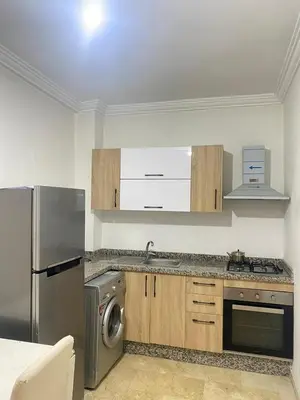 a kitchen with a stainless steel refrigerator and a dishwasher at Cosy & magnifique appartement Marrakech in Marrakech