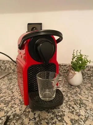 a red coffee maker with a glass on a counter at Cosy & magnifique appartement Marrakech in Marrakech