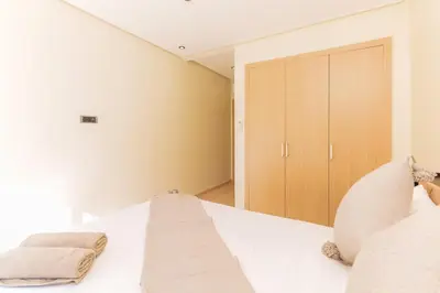 a bedroom with a white bed and a closet at Relax Front Of Pool-Garden-Fibre in Marrakech