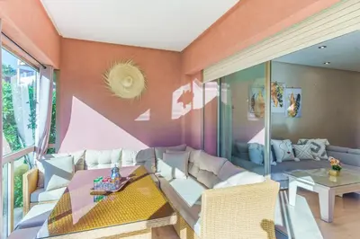 a living room with a couch and a table at Relax Front Of Pool-Garden-Fibre in Marrakech