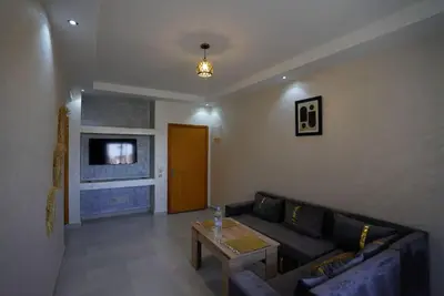 a living room with a couch and a table at Comfy family flat 10 mins from Medina in Marrakech