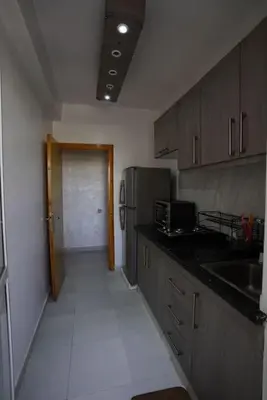 a kitchen with a sink and a refrigerator at Comfy family flat 10 mins from Medina in Marrakech