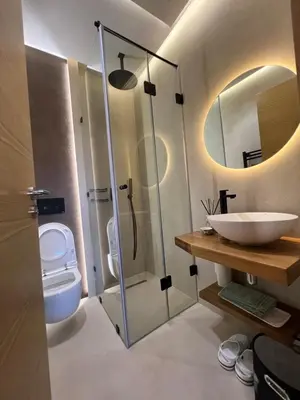 a bathroom with a shower and a toilet and a sink at Luxe appartement à louer pour les familles in Marrakech