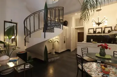 a living room with a table and a dining room at Riad Garden House Marrakech in Marrakech