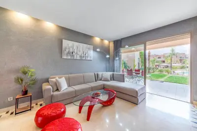 a living room with a couch and a table at Relaxing Summer-Pool-Garden-Wifi in Marrakech