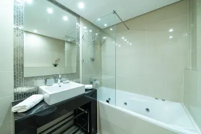 a bathroom with a sink and a tub and a mirror at Relaxing Summer-Pool-Garden-Wifi in Marrakech