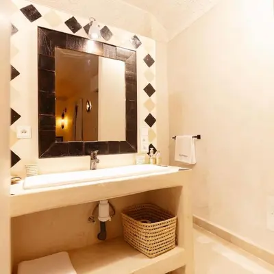 a bathroom with a sink and a mirror at Riad Wadiya, privatif, piscine en rooftop. in Marrakech