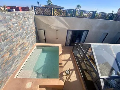 a swimming pool on the side of a building at Riad Wadiya, privatif, piscine en rooftop. in Marrakech
