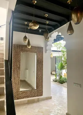 a mirror on a wall in a room with lights at Riad Wadiya, privatif, piscine en rooftop. in Marrakech