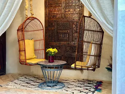 a room with two bird cages and a table at Riad 11 Zitoune in Marrakech