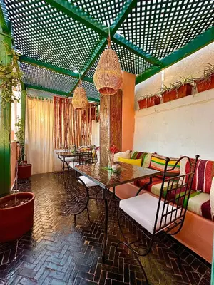 a living room with a table and a couch at Riad 11 Zitoune in Marrakech