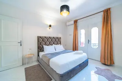 a bedroom with a large bed and a window at Central appartement in the heart of Guéliz in Marrakech