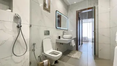 a bathroom with a toilet and a sink and a shower at Villa KOEUR, piscine chauffée sans vis-à-vis à Marrakech in Marrakech