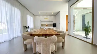 a dining room with a wooden table and chairs at Villa KOEUR, piscine chauffée sans vis-à-vis à Marrakech in Marrakech
