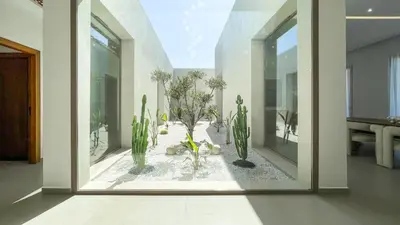 a room with cactuses and plants in a window at Villa KOEUR, piscine chauffée sans vis-à-vis à Marrakech in Marrakech