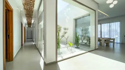 a hallway with a large glass door with a dog in it at Villa KOEUR, piscine chauffée sans vis-à-vis à Marrakech in Marrakech