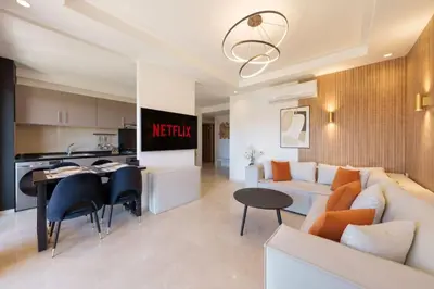a living room and kitchen with a couch and a table at Belle vue, noria golf in Marrakech