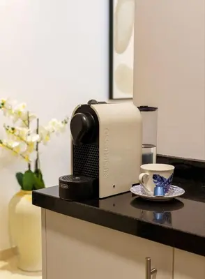 a kitchen counter with a toaster and a cup of coffee at Belle vue, noria golf in Marrakech