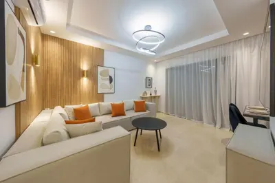 a living room with a white couch and a table at Belle vue, noria golf in Marrakech