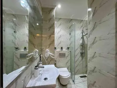 a bathroom with a sink and a toilet and a shower at Bel Appart Familial Majorelle in Marrakech