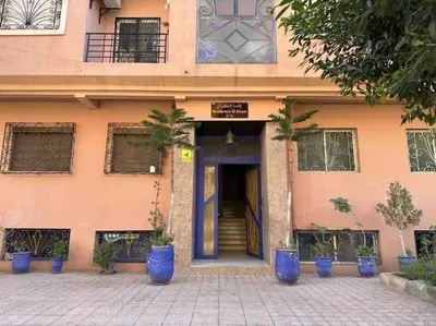 a building with blue potted plants in front of it at Bel Appart Familial Majorelle in Marrakech