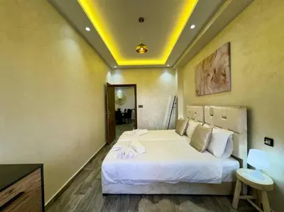 a bedroom with a large white bed in a room at Bel Appart Familial Majorelle in Marrakech