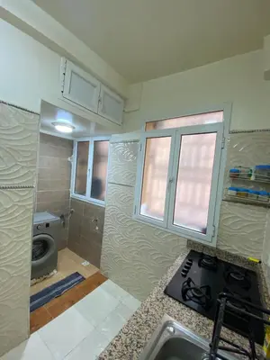 a kitchen with a sink and a stove in it at Confort Abordable Louez Notre Appartement in Marrakech