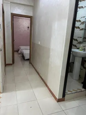 a bathroom with a mirror and a sink and a bedroom at Confort Abordable Louez Notre Appartement in Marrakech