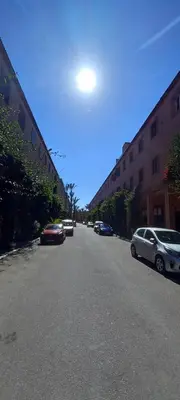 a street with cars parked on the side of a building at Riad Nour Resorts in Marrakech