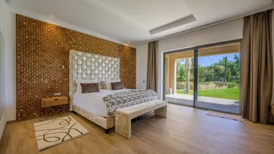 a bedroom with a bed and a brick wall at Villa Maria, Luxury Marrakech in Marrakech