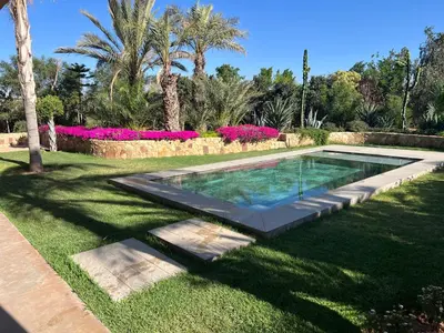 a swimming pool in the middle of a yard at Villa Maria, Luxury Marrakech in Marrakech