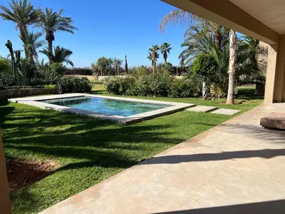 a swimming pool in the yard of a house at Villa Maria, Luxury Marrakech in Marrakech
