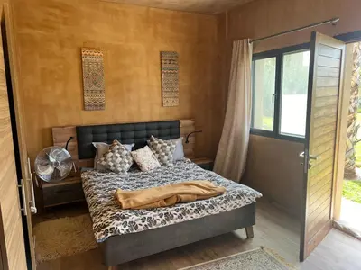 a bedroom with a bed and a glass door at Villa Maria, Luxury Marrakech in Marrakech