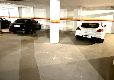 two cars are parked in a parking garage at Appartement Denda in Marrakech