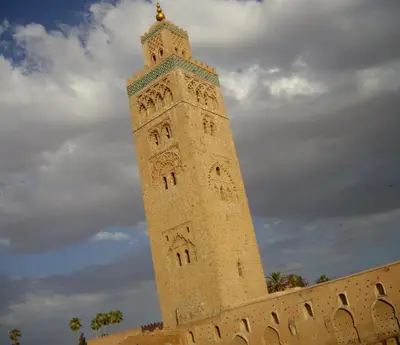a tall clock tower in front of a building at Cheap accommodation in Marrakech in Marrakech