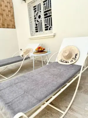 a room with two beds and a table at Maison de ville avec piscine in Marrakech