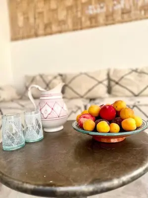 a bowl of fruit on top of a table at Maison de ville avec piscine in Marrakech