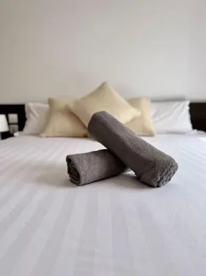 two rolled up towels on top of a bed at Maison de ville avec piscine in Marrakech
