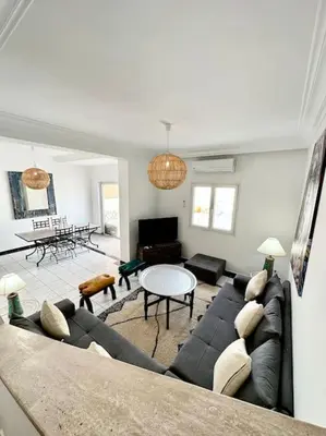 a living room with a couch and a table at Maison de ville avec piscine in Marrakech