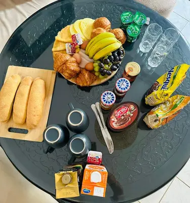 a glass table with a plate of food on it at Maison de ville avec piscine in Marrakech