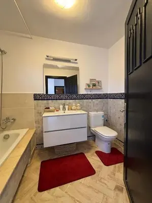 a bathroom with a sink and a toilet and a tub at Cozy apartment with roof top in Marrakech