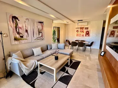 a living room with a couch and a table at New appart, pool and golf view in Marrakech