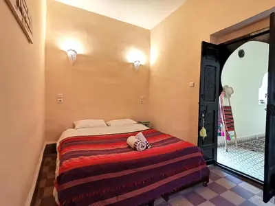 a bedroom with a bed with a towel on it at Dar Mirai in Marrakech