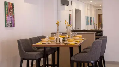 a dining room table with chairs and a dining room table at Loft Atlas in Marrakech