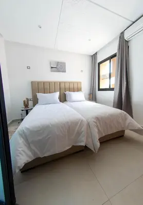 a bedroom with a large bed with white sheets at Loft Atlas in Marrakech
