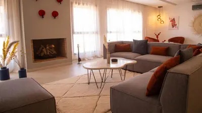 a living room with a couch and a fireplace at Loft Atlas in Marrakech