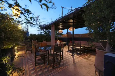 a patio with a table and chairs on a patio at Riad Bindoo & Spa in Marrakech