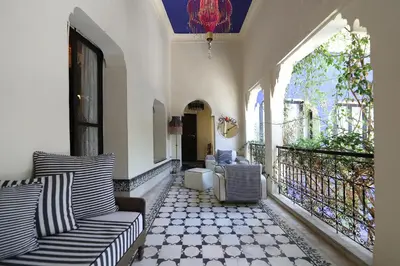 a porch with two couches on a balcony at Riad Bindoo & Spa in Marrakech