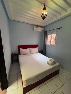 a bedroom with a large bed in a room at Riad Paolo Piscine Palmeraie in Marrakech