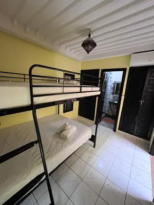 a bedroom with two bunk beds in a room at Riad Paolo Piscine Palmeraie in Marrakech